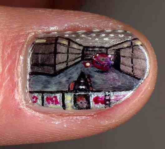 Doom Guy fighting a Beholder painted on someone's nail.